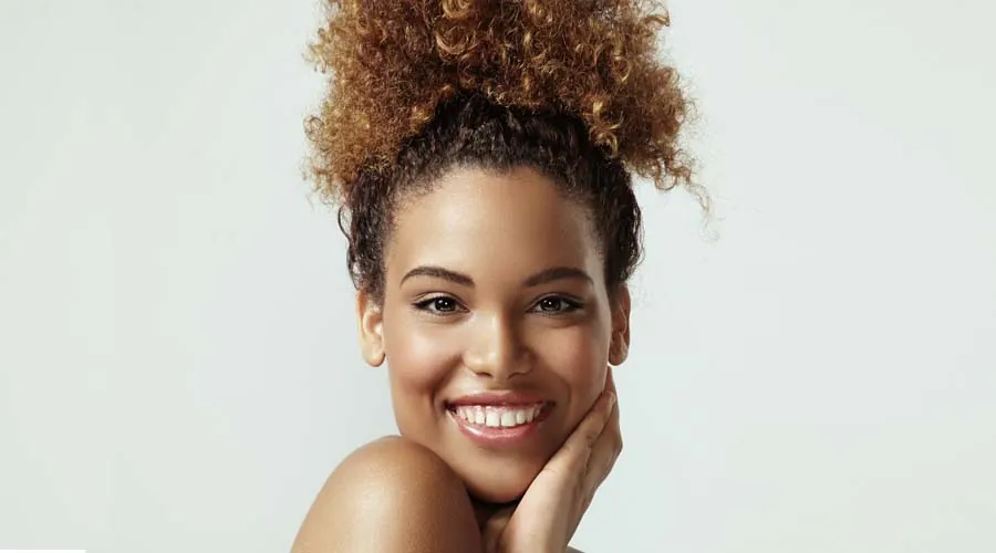 Woman with beautiful, healthy skin on a light green background