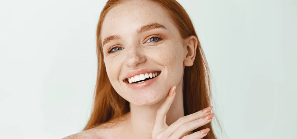 Woman admiring her skin during skin care awareness month